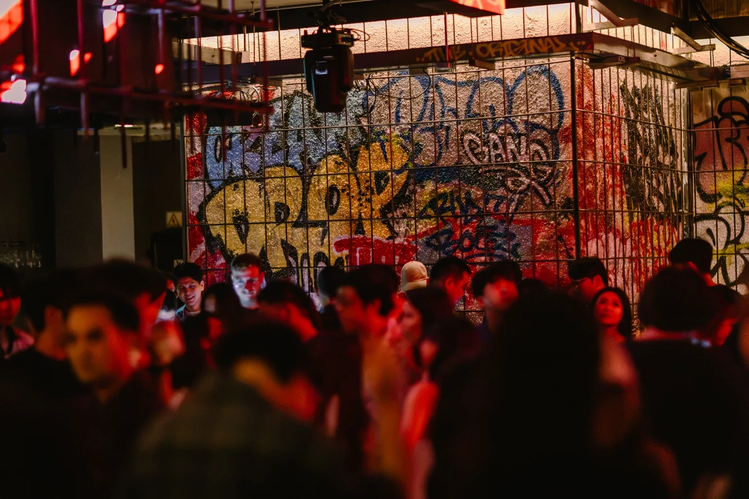 Friends beneath the graffiti wall at Dope & Dirty